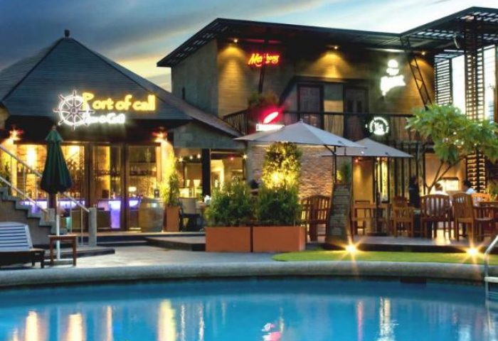Tawana Bangkok Hotel's pool view at dusk. Gay-friendly hotel with bars, restaurants, and a relaxing pool. Perfect for gay travelers.