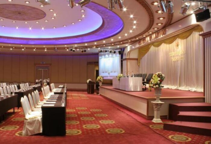Tawana Bangkok Hotel ballroom. Gay-friendly hotel with stage, seating, and ornate ceiling. Perfect for events in Bangkok, Thailand.