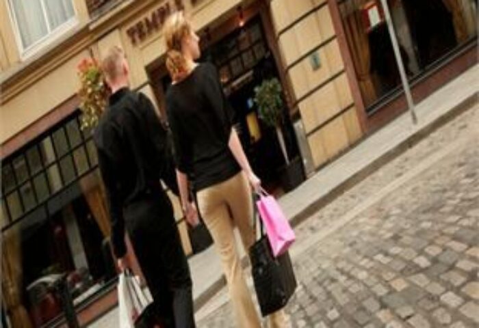 Gay-friendly Temple Bar Hotel: Couple walks past the hotel. The hotel is in the Temple Bar area of Dublin. Gay travel destination.