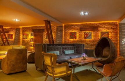 Temple Bar Inn's stylish lounge area. Gay-friendly hotel in Dublin, Ireland, features exposed brick, modern seating, and artistic decor.