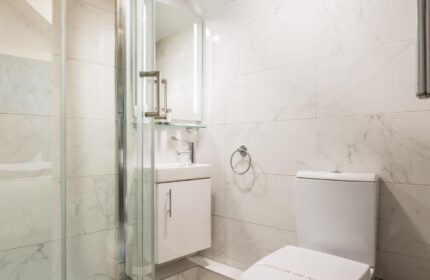 Temple Bar Lane by the KeyCollections gay-friendly hotel: bathroom with shower, sink, toilet, white marble tiles. Modern, clean design.