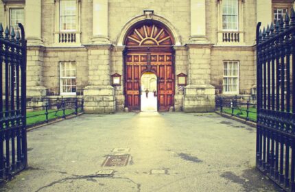 Temple Bar Lane by The KeyCollections: Grand entrance to a gay-friendly hotel in Dublin. Arched doorway, stone facade, and wrought iron gate.
