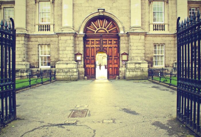 Temple Bar Lane by The KeyCollections: Grand entrance to a gay-friendly hotel in Dublin. Arched doorway, stone facade, and wrought iron gate.