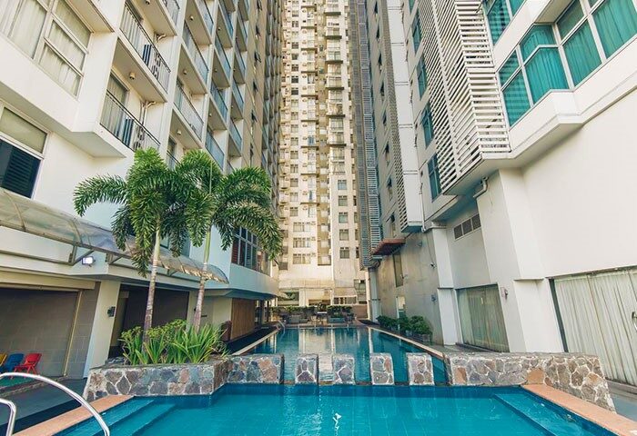 The A. Venue Hotel pool. Gay-friendly hotel with palm trees. A great place for gay men to relax and enjoy their vacation.