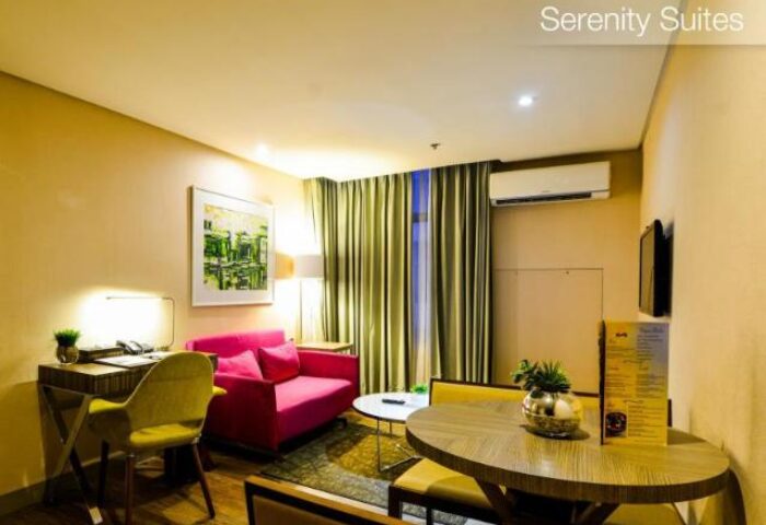 The A. Venue Hotel's gay-friendly room. A cozy suite with a pink sofa, desk, and dining table. A great choice for gay travelers.