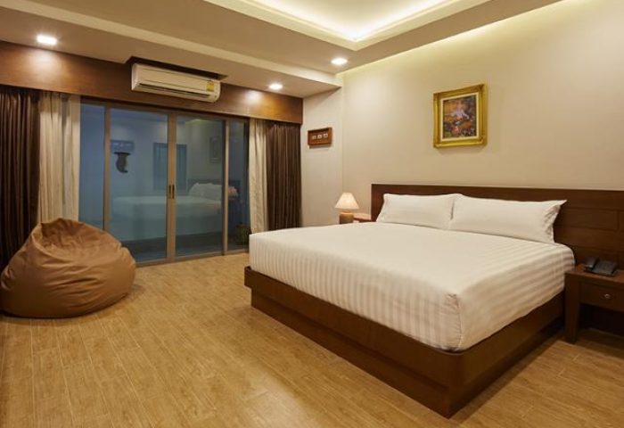 The Agate Pattaya Boutique Resort room. Gay-friendly hotel with king bed, beanbag chair, balcony. Thailand travel.