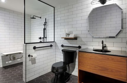 The Anndore House, part of JVD by Hyatt, bathroom. Gay-friendly hotel with black fixtures, white subway tile, and accessible shower.
