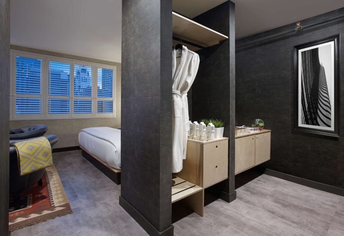 The Anndore House, part of JVD by Hyatt, a gay-friendly hotel. Room interior with bed, chair, closet, and modern decor. Stylish stay.