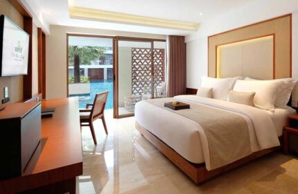 The Bandha Hotel & Suites room. Gay-friendly hotel with a king bed, desk, and balcony overlooking the pool. Modern decor. Relaxing vacation.