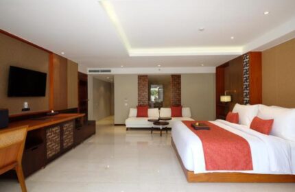 The Bandha Hotel & Suites gay-friendly hotel room. Modern design with a king bed, sofa, and TV. Ideal for gay travel in Bali.