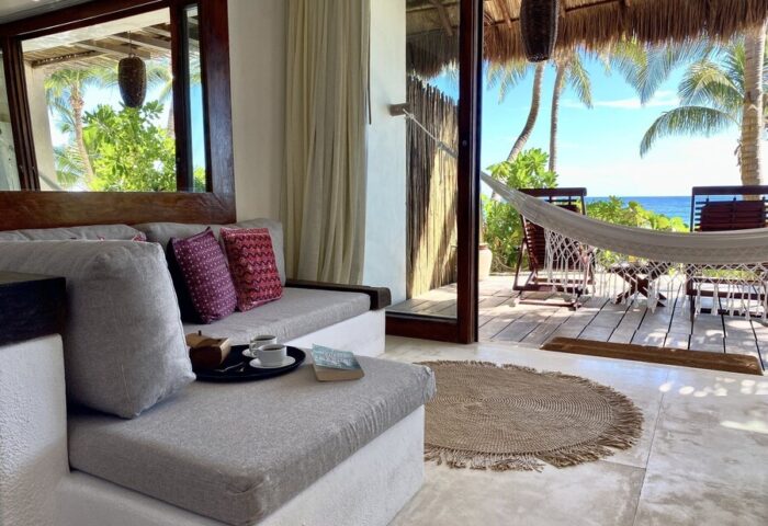 The Beach Tulum Hotel: Gay-friendly hotel room view with hammock, ocean, and lounge area. Perfect for gay men's travel in Tulum.