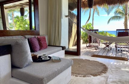 The Beach Tulum Hotel: Gay-friendly hotel room view with hammock, ocean, and lounge area. Perfect for gay men's travel in Tulum.