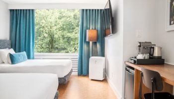 The Burrard Hotel guest room with two beds, desk, TV, coffee maker, and a view. Gay-friendly hotel for gay men travelers.