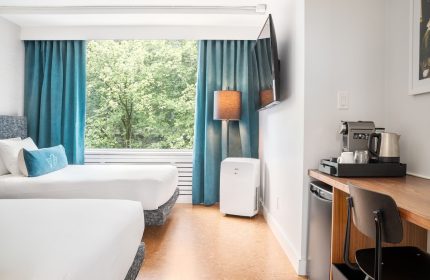 The Burrard Hotel guest room with two beds, desk, TV, coffee maker, and a view. Gay-friendly hotel for gay men travelers.