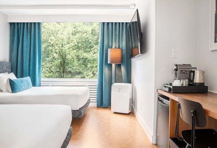 The Burrard Hotel guest room with two beds, desk, TV, coffee maker, and a view. Gay-friendly hotel for gay men travelers.