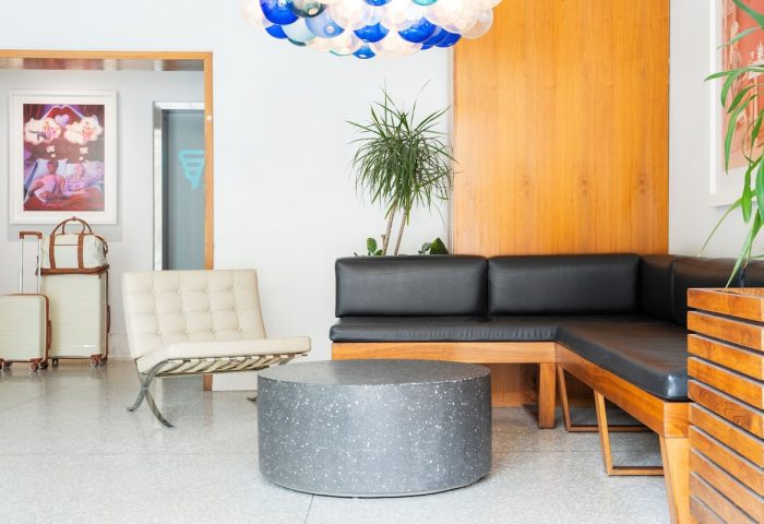 The Burrard Hotel's stylish lobby. Gay-friendly hotel with modern design, seating area, and luggage. Ideal for gay men travel in Vancouver.
