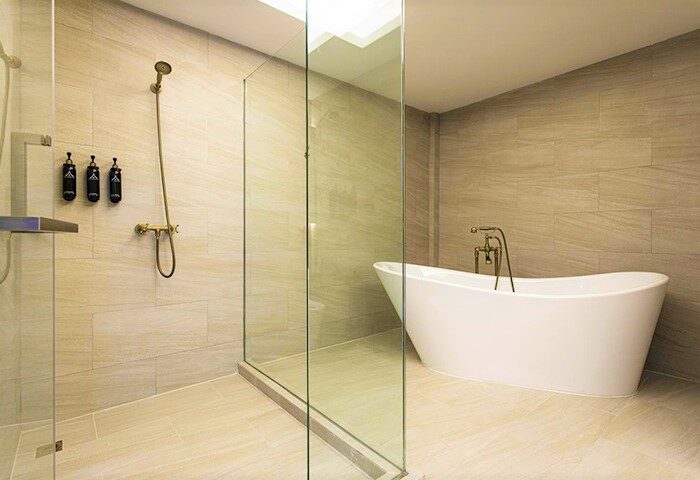 Bathroom at The Chiang Mai Old Town Hotel. Gay-friendly hotel with a bathtub and shower. Luxury amenities for gay travelers in Thailand.