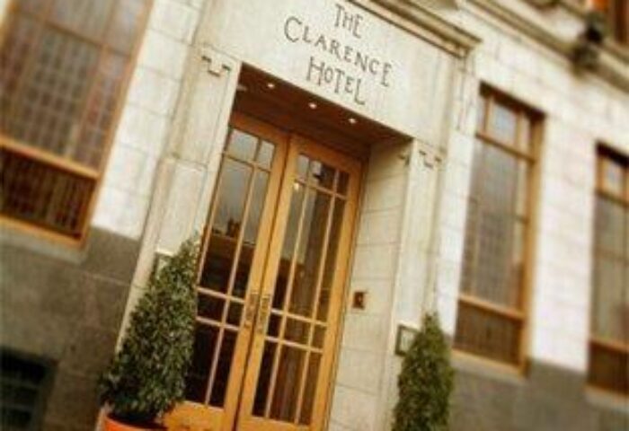 The Clarence Hotel entrance. Gay-friendly hotel in Dublin, Ireland. Stylish doors, stone facade, and potted plants. A great choice for gay travel.