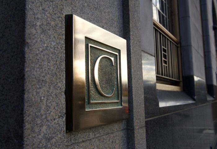 The Clarence, a gay-friendly hotel: bronze 'C' logo on the building's exterior. A great choice for gay travelers in search of welcoming accommodations.