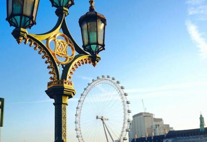 London Eye view from The Clermont London Charing Cross, a gay-friendly hotel. Features a classic street lamp, river, and city skyline.