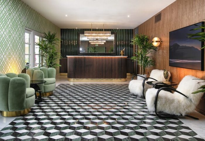 The Colony Palms Hotel lobby. Gay-friendly hotel with geometric floor, green chairs, and reception desk. Stylish interior design.