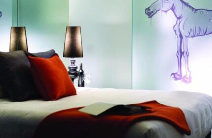 The Cullen Melbourne Art Series hotel room. Gay-friendly hotel with modern art, lamps, pillows, and bed. Great for gay travel in Melbourne.