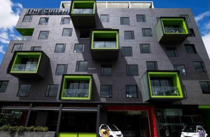 The Cullen Melbourne Art Series, a gay-friendly hotel. Unique architecture, with boxy balconies and two Smart cars parked outside.