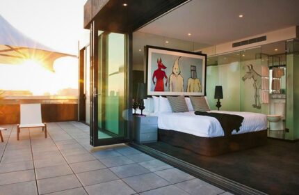 The Cullen Melbourne Art Series Hotel: bedroom with balcony. Gay-friendly hotel featuring modern art and luxurious accommodations. Melbourne travel.