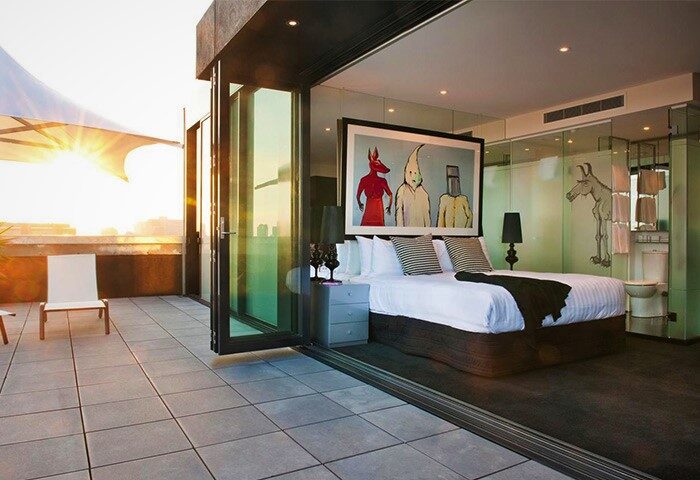 The Cullen Melbourne Art Series Hotel: bedroom with balcony. Gay-friendly hotel featuring modern art and luxurious accommodations. Melbourne travel.