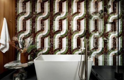 Bathroom at The Drake Hotel, gay-friendly hotel. Retro tile design, white tub, and modern fixtures. Stylish gay travel lodging.