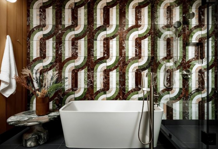 Bathroom at The Drake Hotel, gay-friendly hotel. Retro tile design, white tub, and modern fixtures. Stylish gay travel lodging.