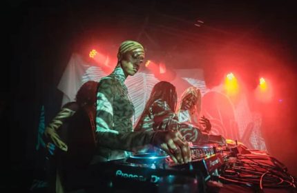 Nightlife at The Drake Hotel, a gay-friendly hotel. DJs performing, red lights, and a vibrant atmosphere. Great for gay men's travel advice.