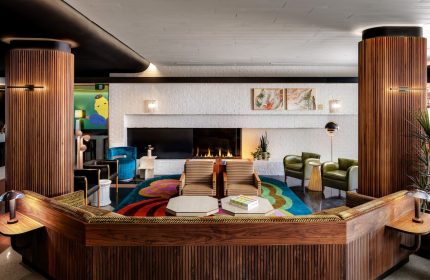 The Drake Hotel's stylish lobby. This gay-friendly hotel features a fireplace, colorful rug, and modern design elements. A great space for LGBT travelers.