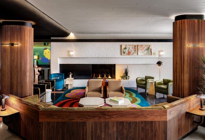The Drake Hotel's stylish lobby. This gay-friendly hotel features a fireplace, colorful rug, and modern design elements. A great space for LGBT travelers.