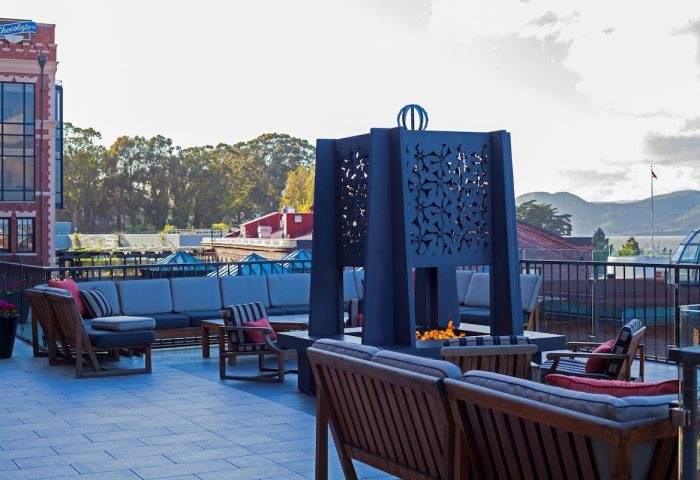 Fairmont Heritage Place Ghirardelli Square gay-friendly hotel: Outdoor terrace with fireplace, seating, and views. Ideal for gay travelers.