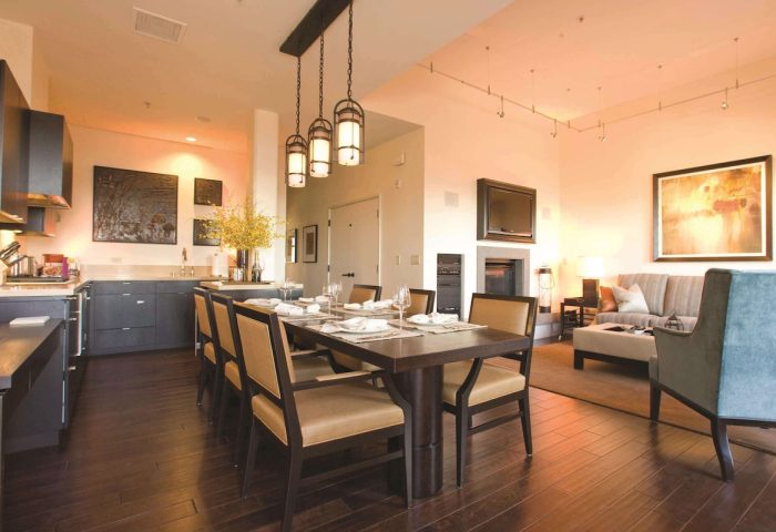 Fairmont Heritage Place Ghirardelli Square interior. Dining table, chairs, kitchen, living room. Gay-friendly hotel suite.