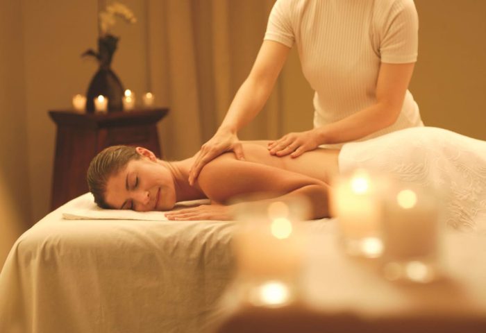 Fairmont Heritage Place Ghirardelli Square spa. Woman receiving a massage in a serene setting. Gay-friendly hotel wellness.