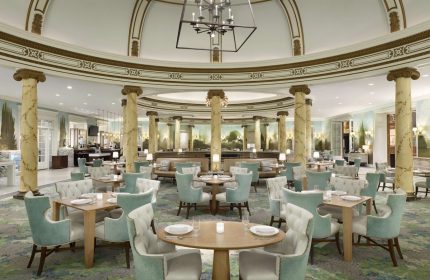 Elegant dining room at the Fairmont San Francisco Hotel. Gay-friendly hotel with luxurious decor, tables, and chairs. Fine dining experience.
