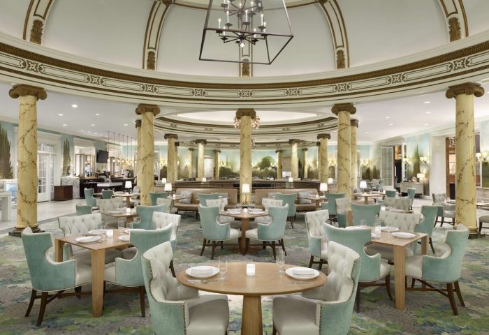 Elegant dining room at the Fairmont San Francisco Hotel. Gay-friendly hotel with luxurious decor, tables, and chairs. Fine dining experience.