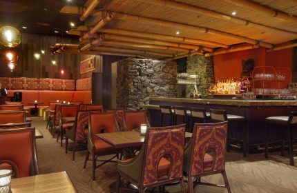 Gay-friendly The Fairmont San Francisco Hotel's Tonga Room & Hurricane Bar. Bamboo ceiling, stone details, and tropical-themed decor.
