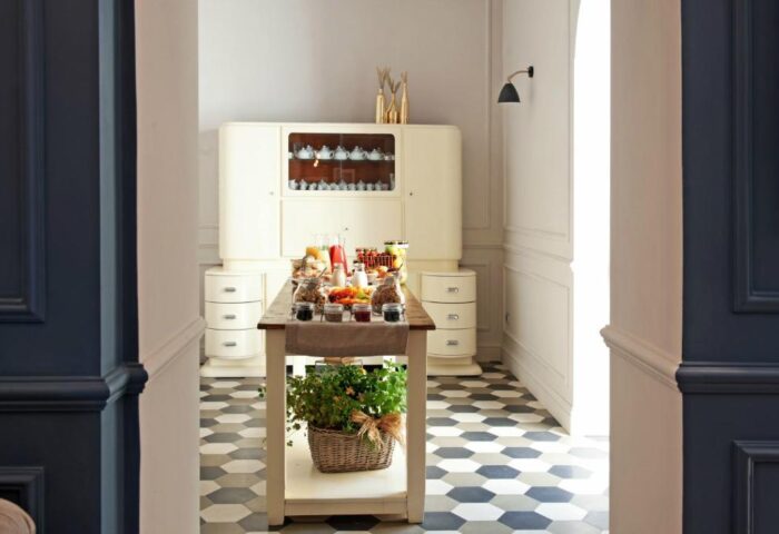 The Fifteen Keys Hotel's pet-friendly breakfast buffet. Gay-friendly hotel with food on a table and a plant in a basket on the bottom shelf.