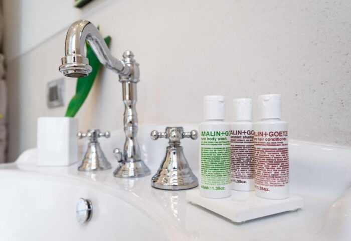 Bathroom sink with Malin+Goetz toiletries at The Fifteen Keys Hotel, a gay-friendly, pet-friendly hotel. Luxury travel for gay men.