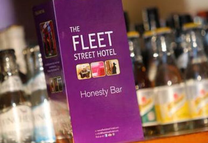 The Fleet Street Hotel's honesty bar menu. Gay-friendly hotel in Dublin, Ireland. Purple menu with drink options, part of The Fleet Hotel experience.
