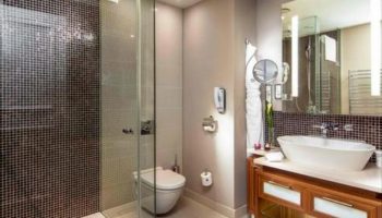 Bathroom at The Grand Mark Prague, a gay-friendly and pet-friendly Leading Hotels of the World. Features a modern shower, sink, and vanity.
