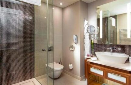 Bathroom at The Grand Mark Prague, a gay-friendly and pet-friendly Leading Hotels of the World. Features a modern shower, sink, and vanity.