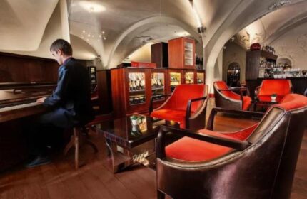 The Grand Mark Prague, a Leading Hotel. Pianist in the lobby bar. Gay-friendly, pet-friendly hotel in Prague. Luxury travel.