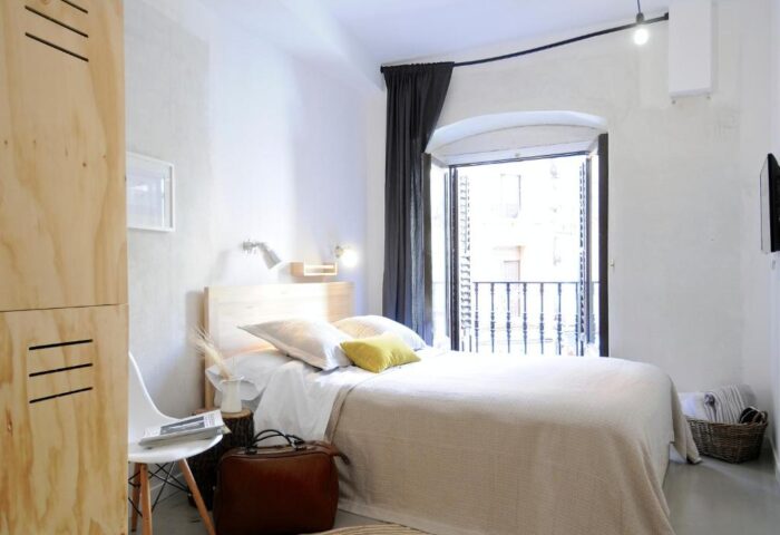 The Hat Hostel Madrid gay-friendly room. Room with double bed and balcony. Gay travel lodging in Madrid, Spain.