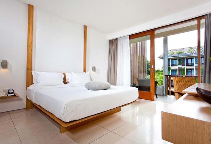 The Haven Bali Seminyak gay-friendly hotel room. Modern design with a large bed, balcony, and view. Bali travel for gay men.