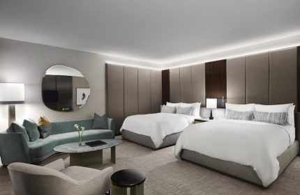 Gay-friendly The Hazelton Hotel room. Two beds, couch, and modern decor. Luxury travel for gay men. Upscale hotel room interior.