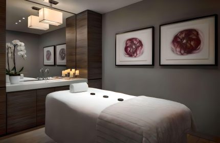 The Hazelton Hotel spa room with massage table, orchids, and artwork. A luxury, gay-friendly hotel for gay men travelers.